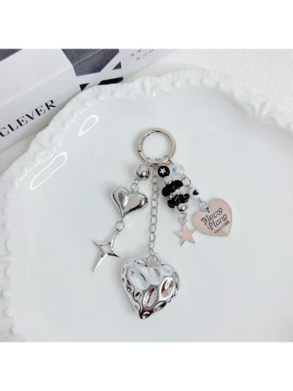 Minimalist heart shaped charm keychain in silver on a white background