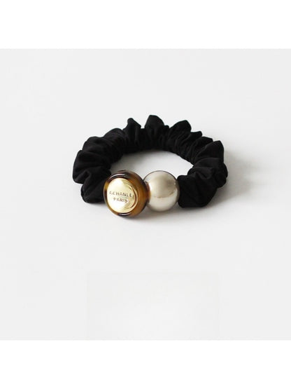Gifty minimalist hair tie holding a ponytail in dark hair