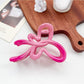 Beau ombre heart shaped bow claw clip displayed with matching accessories in soft lighting