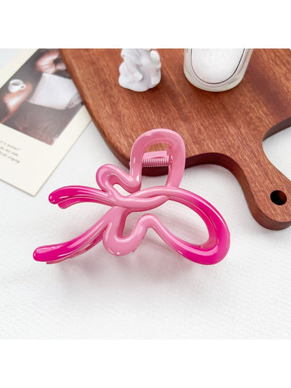 Beau ombre heart shaped bow claw clip displayed with matching accessories in soft lighting