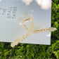 Beau flower crisscross hair claw clip on model's hair from side