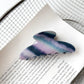 Beau hair claw clip resting on fabric surface with light reflection