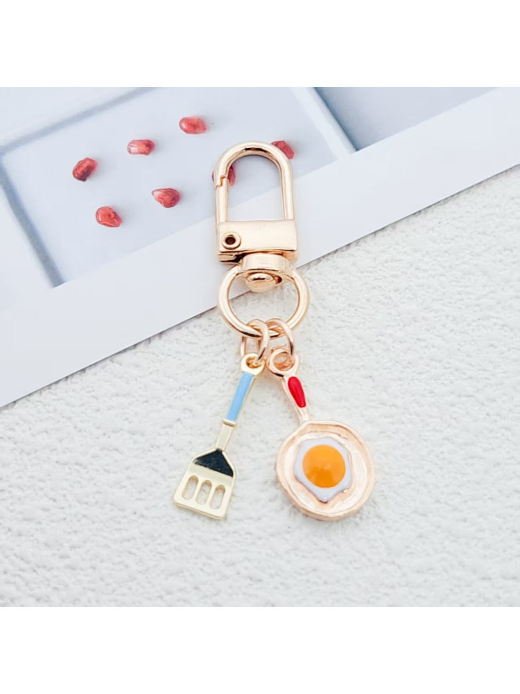 Close-up of fried egg shaped keychain with yellow yolk and white edges