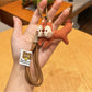 Side view of Keypus squirrel charm keychain showing its bushy tail design