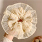 Gifty vintage print scrunchie styled on a wrist with soft fabric texture