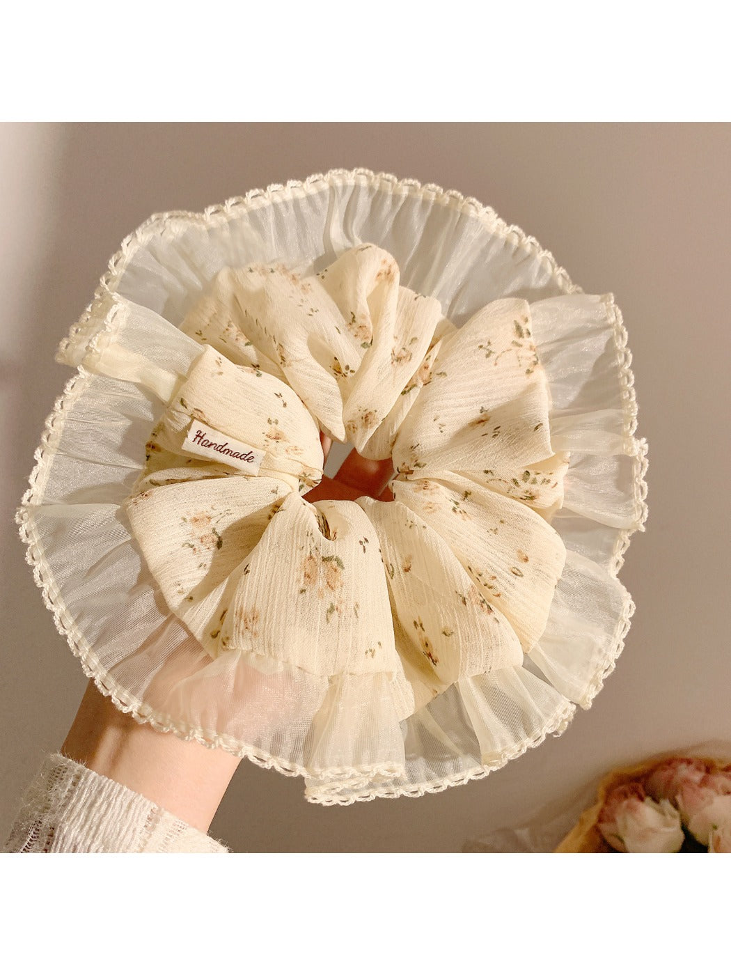 Gifty vintage print scrunchie styled on a wrist with soft fabric texture