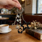 Keychain attached to a set of keys on a wooden surface