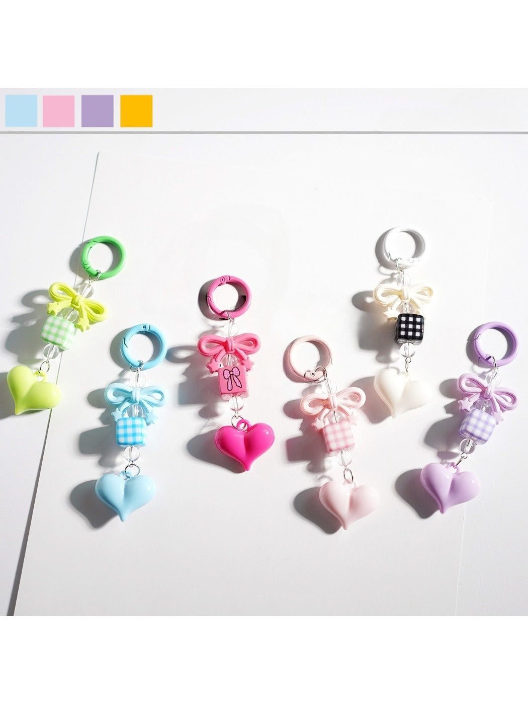 Close-up of Keypus cute bow heart beaded keychain with pink and white beads