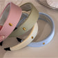 Close-up of soft pastel striped headband fabric texture and stitching details