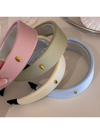 Close-up of soft pastel striped headband fabric texture and stitching details