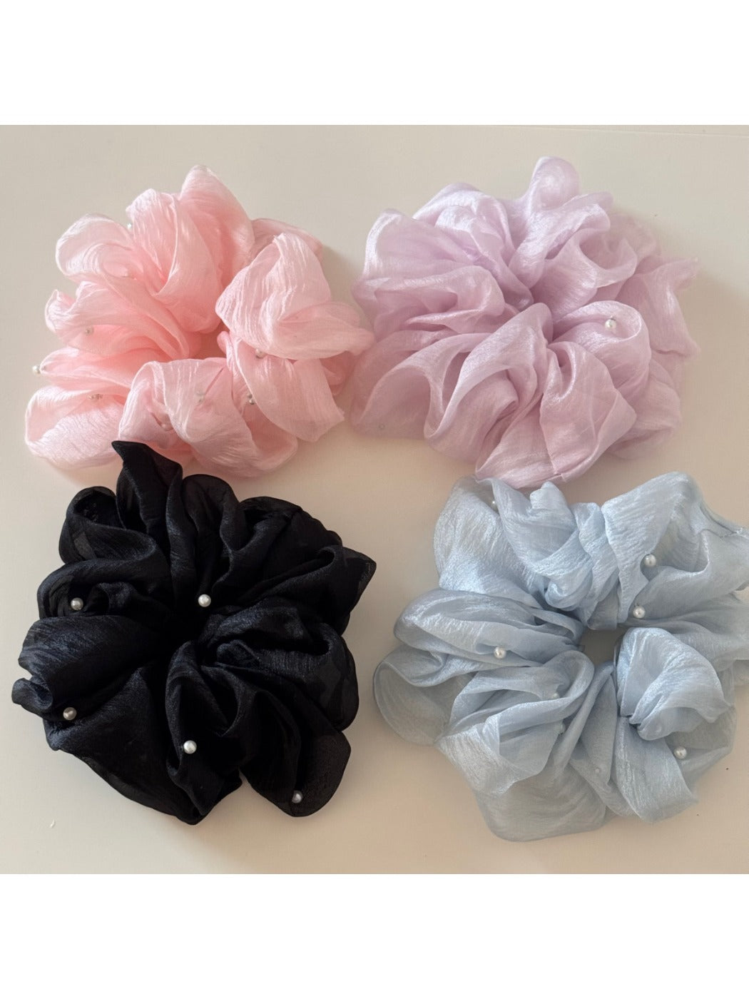 Gifty scrunchie wrapped around a wrist showing its soft, foggy pastel texture