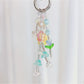 Keypus keychain showing star and flower charms hanging from gold keyring