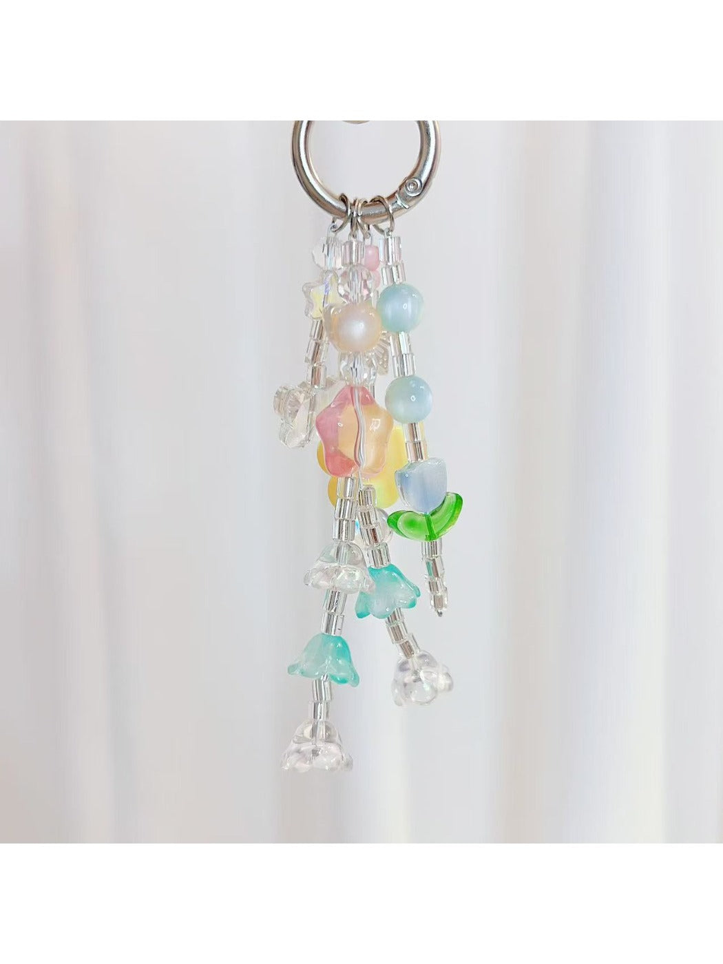 Keypus keychain showing star and flower charms hanging from gold keyring
