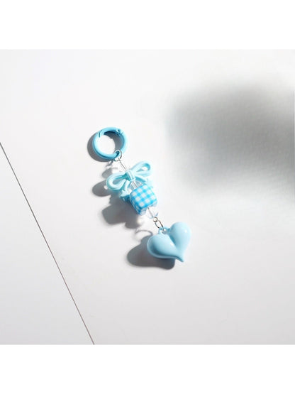 Keypus keychain attached to a bag zipper with pink bow and heart beads