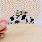 Beau leopard print claw clip next to matching hair accessories