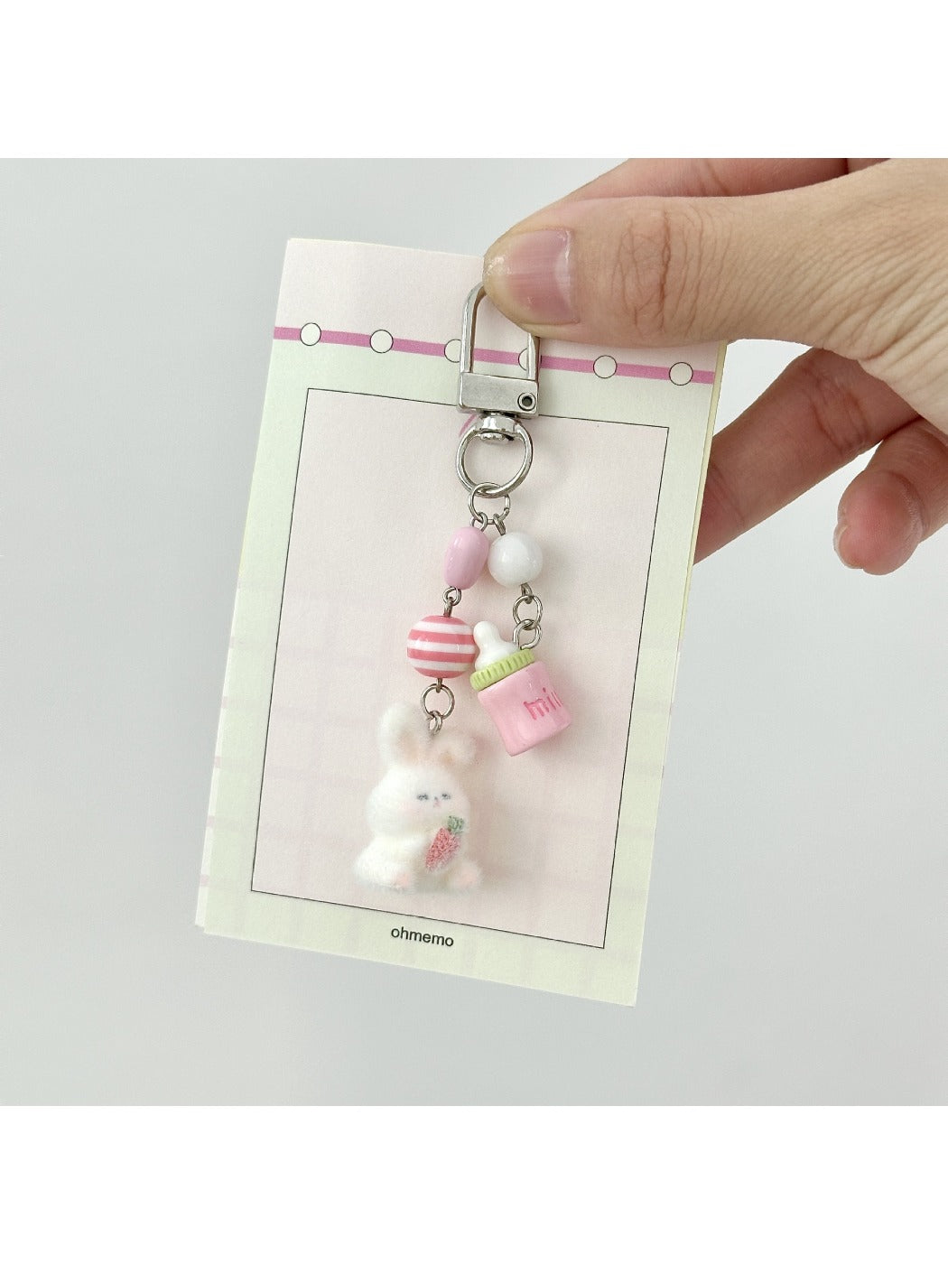 Pink bunny keychain displayed on a white background showing its full shape