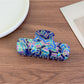 Beau gradient acetate claw clip held in hand to show size and scale