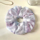 Gifty scrunchie styled with matching accessories on a wooden surface