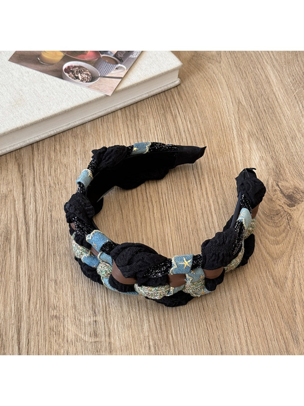 Close-up of black headband showing white star pattern and textured fabric