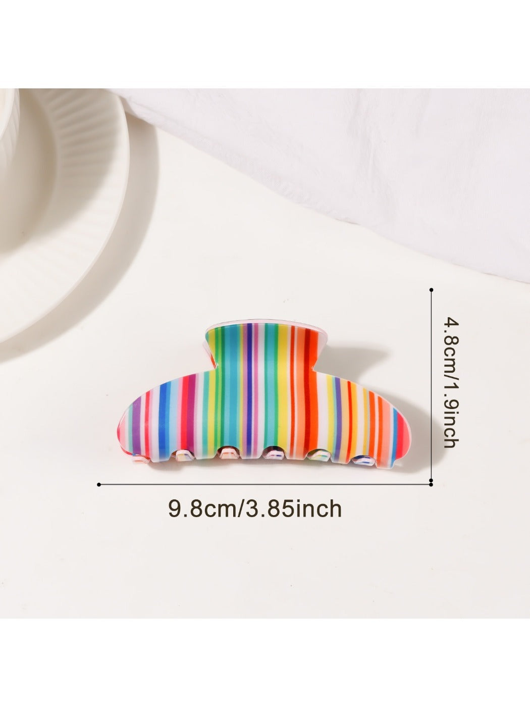 Beau colorful striped half moon claw clip displayed with matching accessories