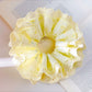 Yellow ruffle scrunchie styled on a model's wrist against a white background