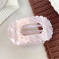 Beau flat open work shark claw clip laying flat, showing overall shape