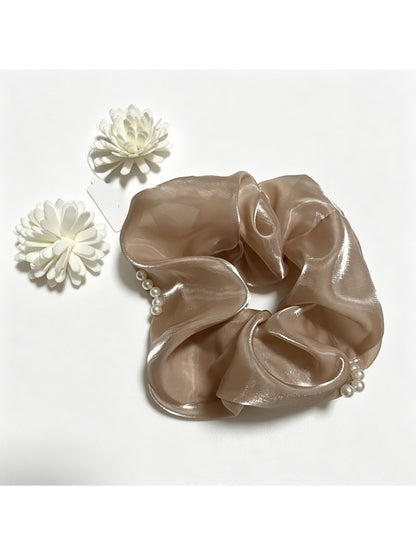 Gifty tulle scrunchie with bead embellishments displayed on a wooden surface