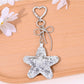 Star shaped keychain attached to a handbag zipper pull