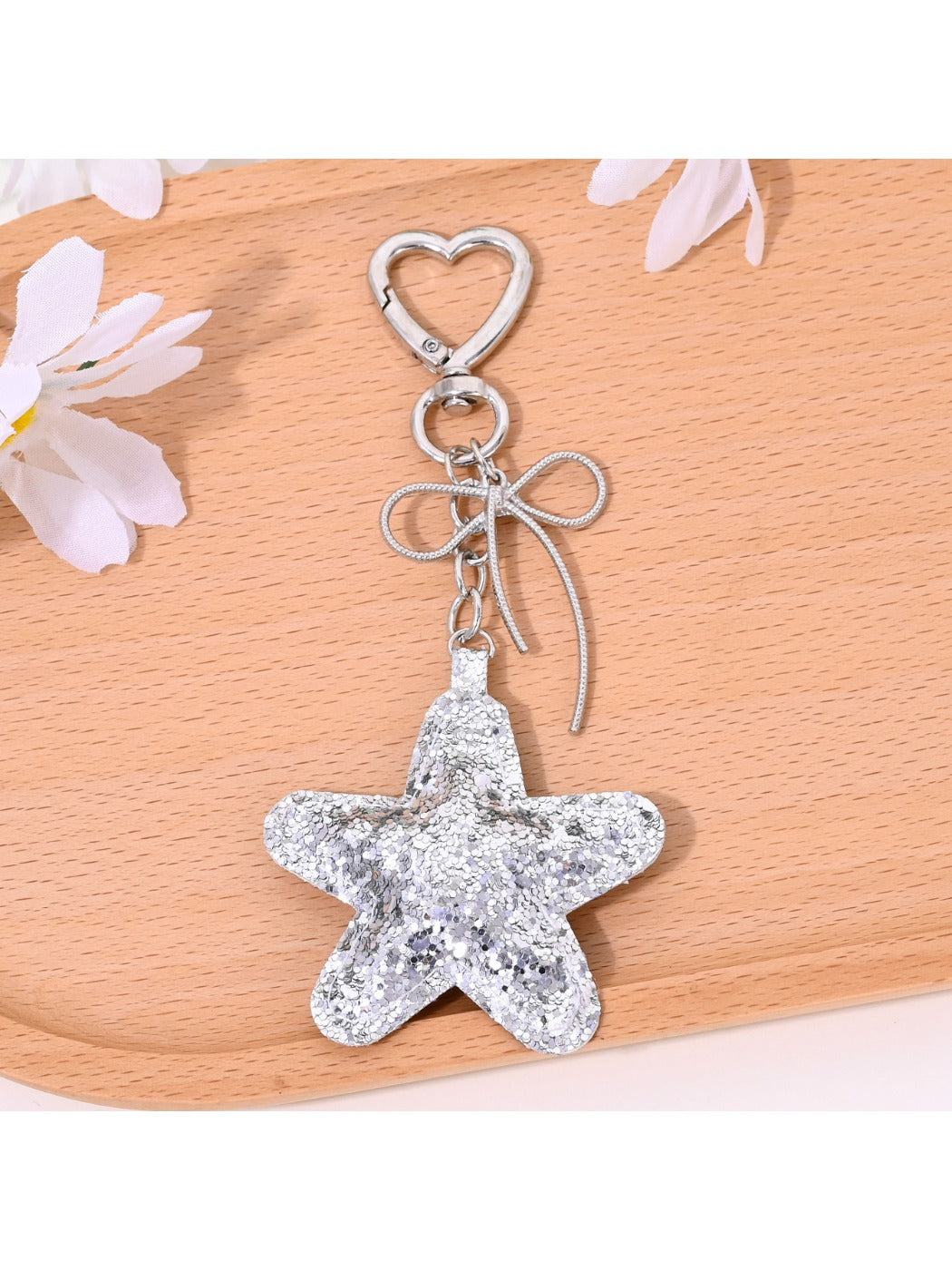 Star shaped keychain attached to a handbag zipper pull