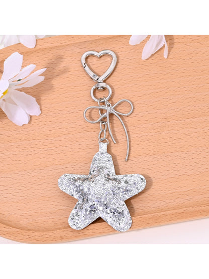 Star shaped keychain attached to a handbag zipper pull
