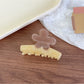 Top view of Beau flower shaped color block claw clip showing petal design
