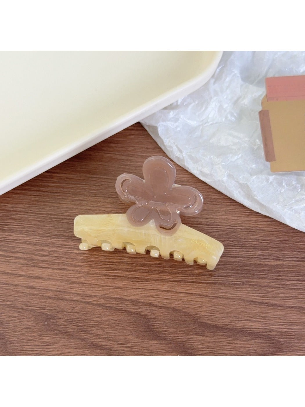 Top view of Beau flower shaped color block claw clip showing petal design