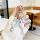 Floral bow charm keychain with pink and white flower design on gold ring