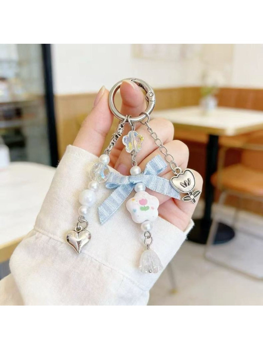 Floral bow charm keychain with pink and white flower design on gold ring