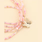 Close-up of Lovra multi strand beaded bracelet featuring delicate butterfly charm