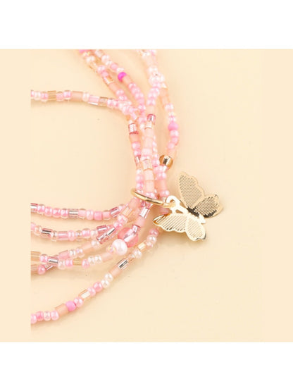 Close-up of Lovra multi strand beaded bracelet featuring delicate butterfly charm