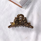 Beau acetate bow shaped claw clip with soft shadows emphasizing shape