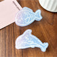 Beau claw clip open showing metal spring mechanism and blue ocean design