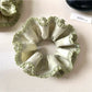 Side view of green double layer scrunchie highlighting its layered design