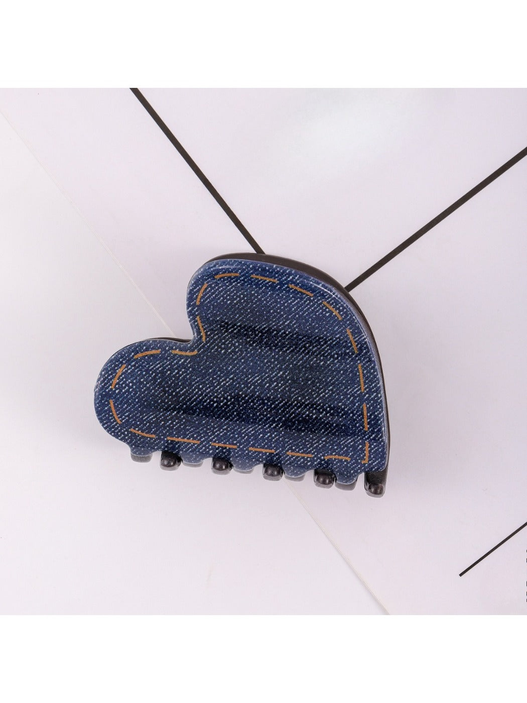 Beau hair clip worn in brown hair, displaying heart design and size