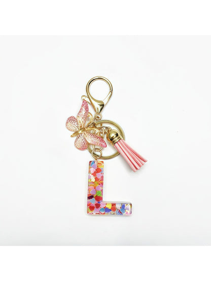 Silver keychain with butterfly and letter pendant hanging from a hook