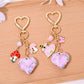 Full rhinestone heart shaped keychain with silver keyring on white background