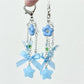 Close-up of blue flower bow keychain showing fabric texture and stitching
