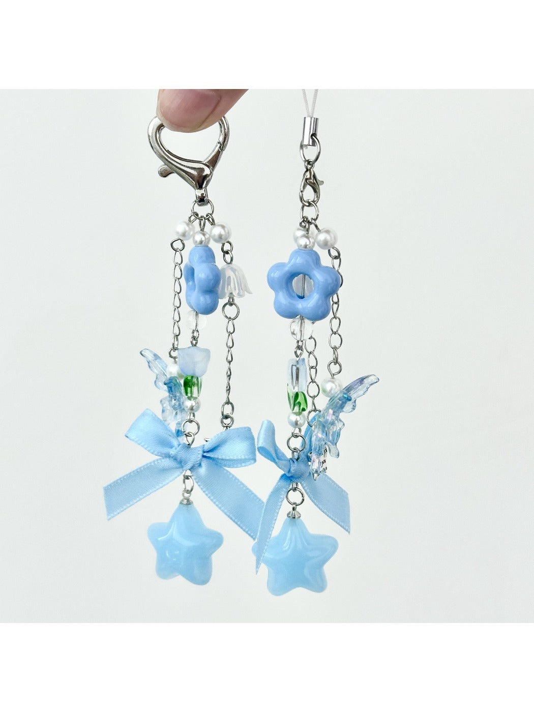 Close-up of blue flower bow keychain showing fabric texture and stitching