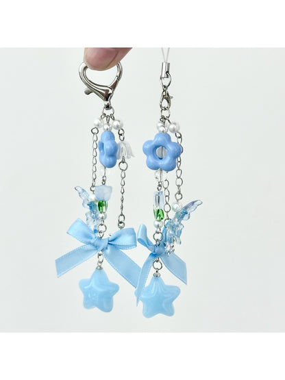 Close-up of blue flower bow keychain showing fabric texture and stitching