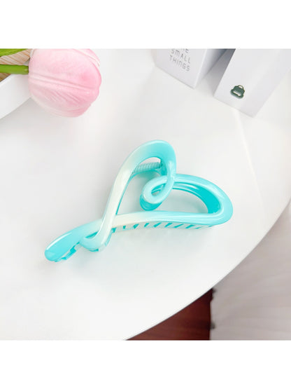 Beau color blocked heart shaped claw clip displayed with matching accessories