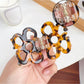 Side view of Beau openwork flower hair claw clip highlighting clip mechanism