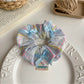 Multiple Gifty Ribbon Bow Plaid Scrunchies in different plaid patterns arranged together