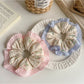Side view of Gifty tiny floral print scrunchie highlighting texture