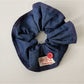 Blue scrunchie and headband set arranged side by side on white background